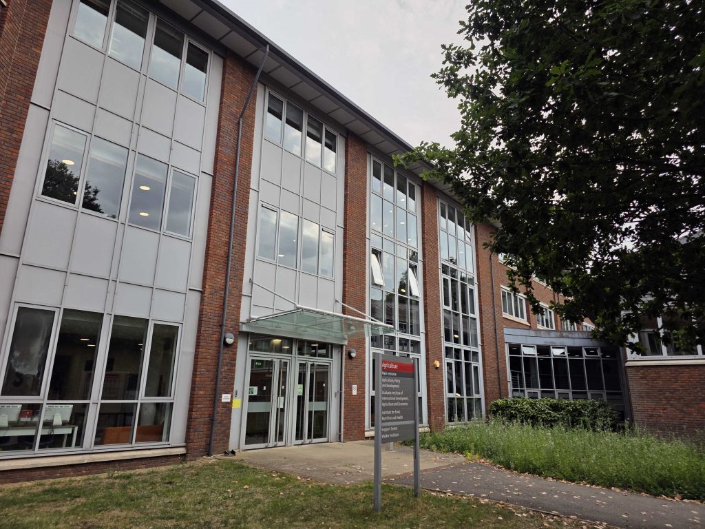 Colour photo of a three storey brick and glass building with a sign on front that says Agriculture.