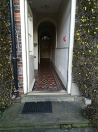 Colour photo of an open doorway leading into a building.