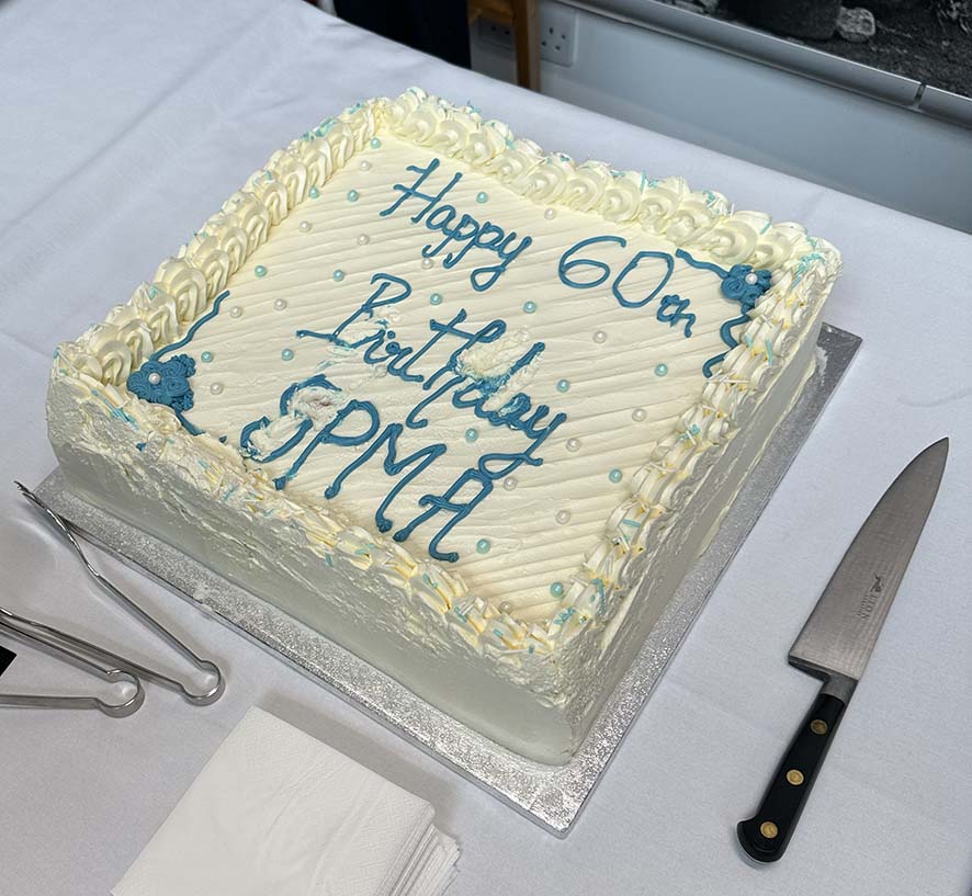 SPMA 60th birthday cake, blue icing on cream.